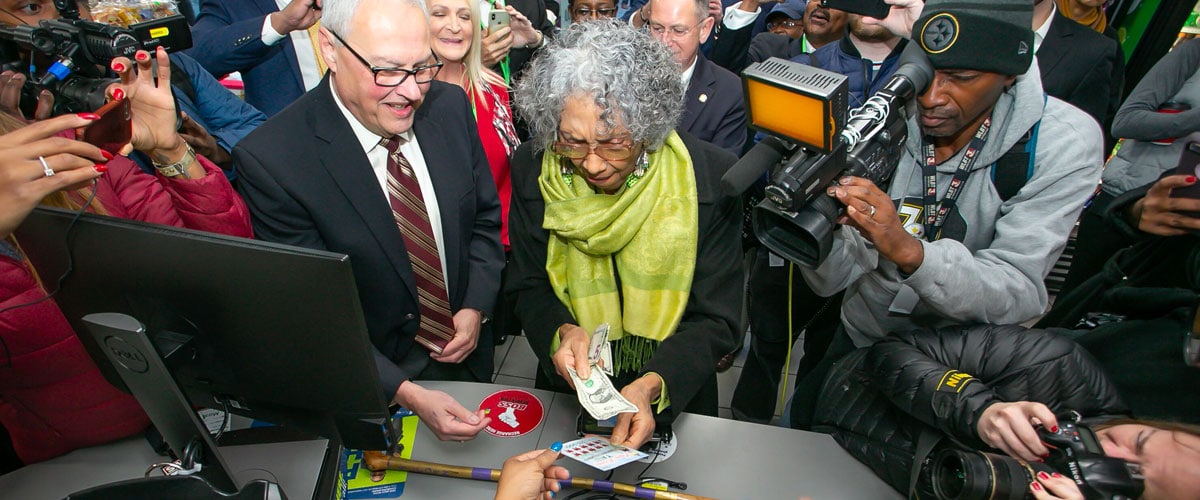 Alyce Clark buying her first scratch-off ticket as sales opened up in Mississippi